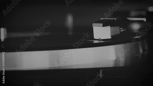 Vinyl record spinning on the turntable in black and white