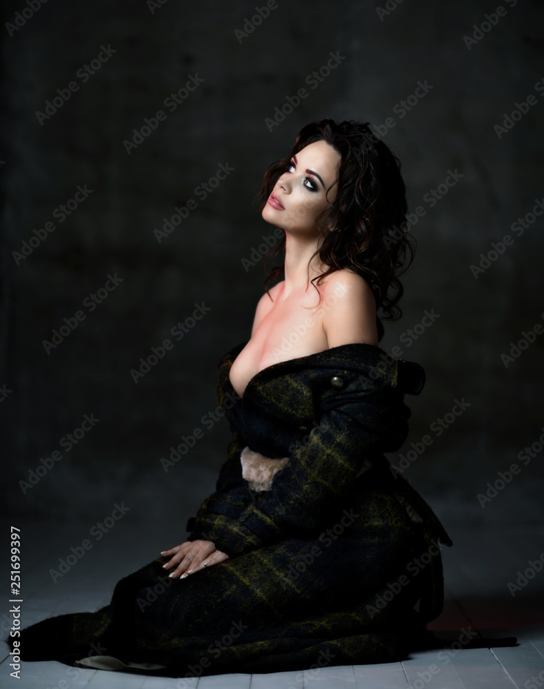 Young sensual beautiful sexy woman posing in summer fashion body jacket naked on dark Young sensual beautiful sexy woman posing in summer fashion body jacket naked on dark