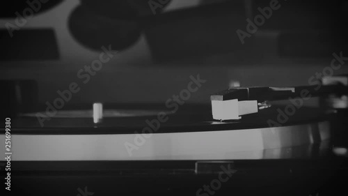Vinyl record spinning on the turntable in black and white