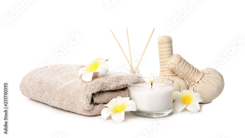 Beautiful spa composition with candle and herbal bags on white background