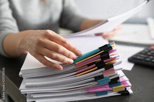 Office employee working with documents at table, closeup photo