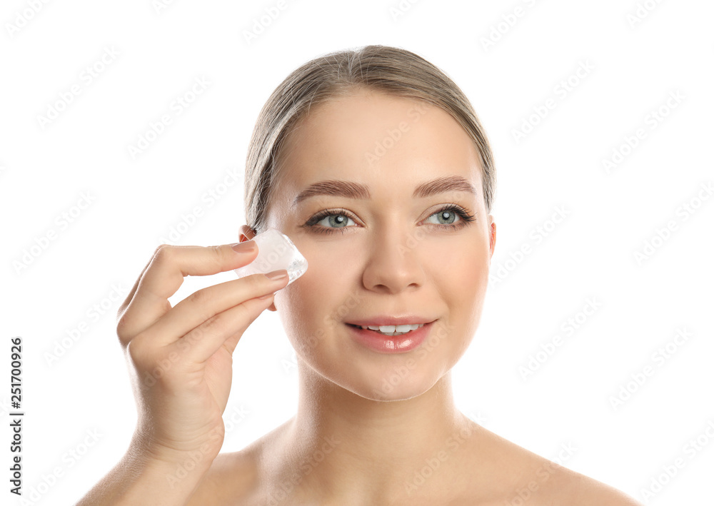 Young woman with ice cube on white background. Skin care