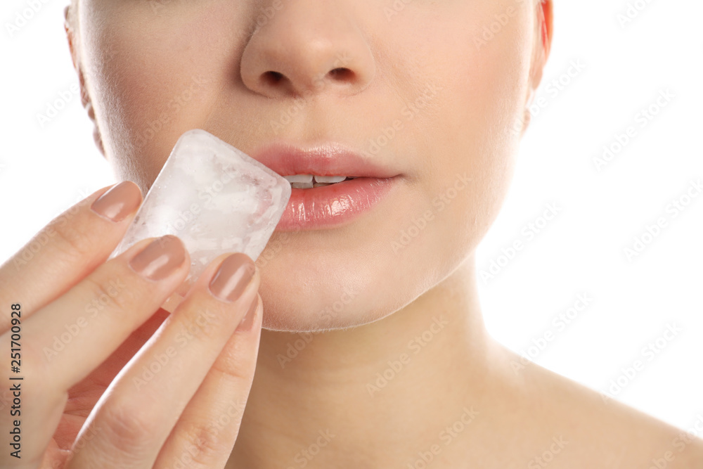 Young woman with ice cube on white background, closeup. Skin care Young woman with ice cube on white background, closeup. Skin care