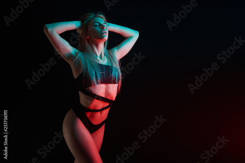 Pole dance girl with perfect body in black sexy lingerie. Night club concept