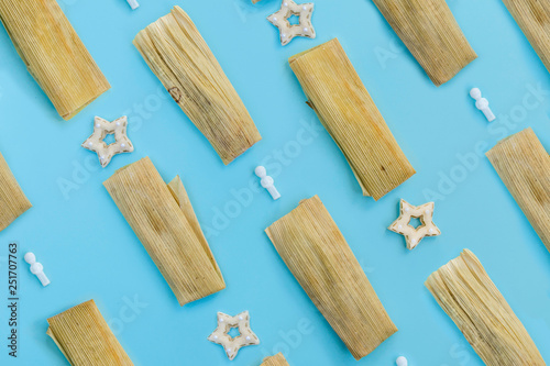 Colorful pattern with tamales, star cookies and the traditional Mexican baby Jesus on blue background. Top View. Copy Space. Pop art design.