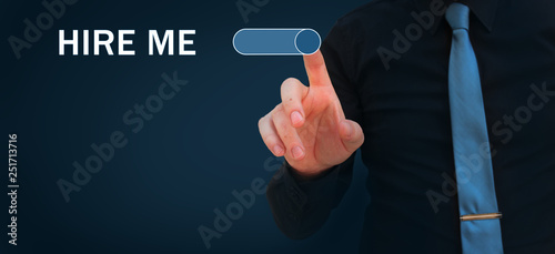 Hire me, give me a job, find a job, looking for a job concepts. Businessman switching on button hire me on virtual screen