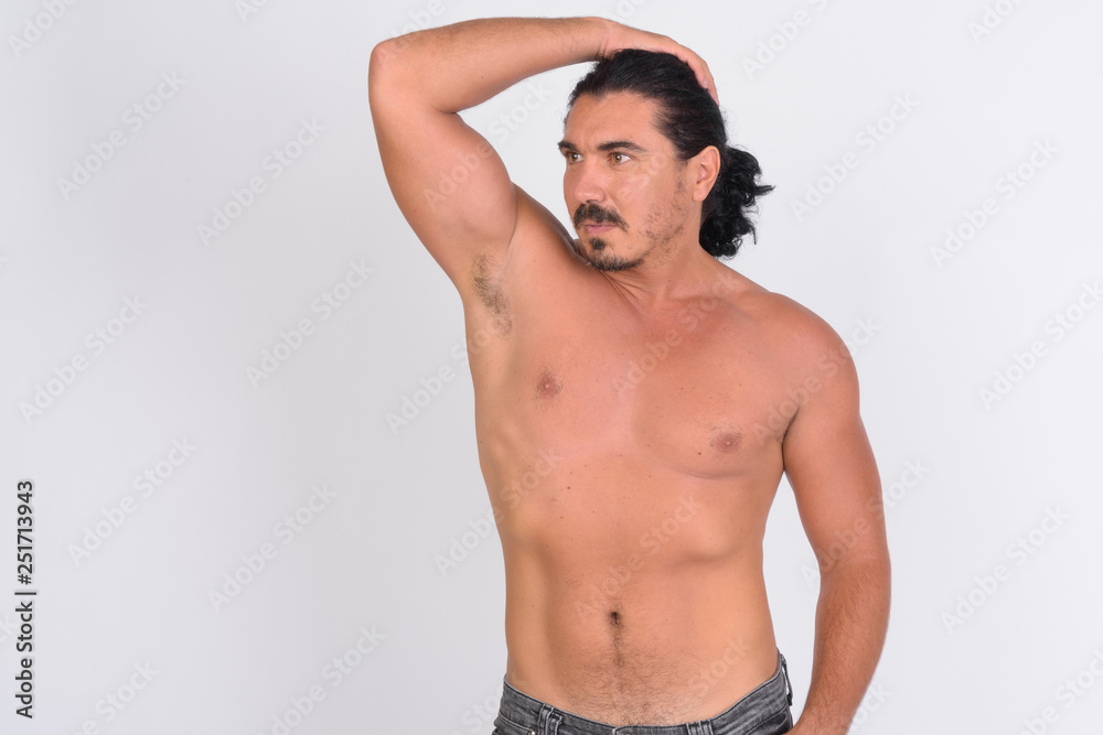 Shirtless handsome macho man with mustache brushing hair back