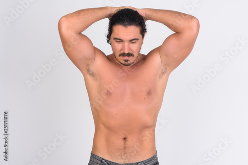 Shirtless handsome macho man with mustache flexing abs