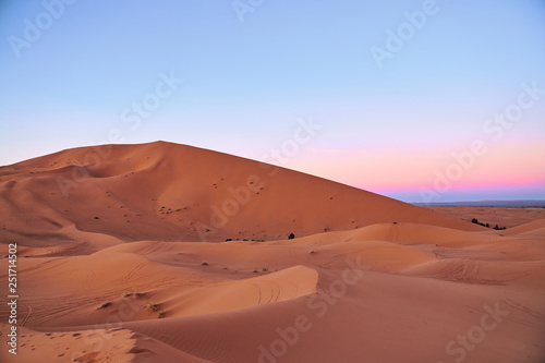 Beautiful pink sunset at big dunes in Sahara desert Morocco Africa