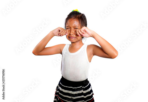 portrait of sweet and cute female child 8 or 9 years old crying sad in pain feeling unhappy and upset isolated on white background in bullying victim kid concept