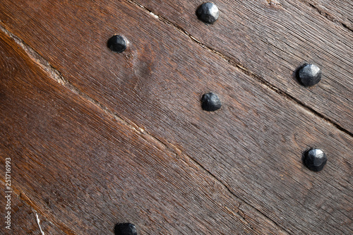  Aged planks with old rivets, bolts, door handle. Basilica on the Holy Mountain, Gostyn, Poland. photo