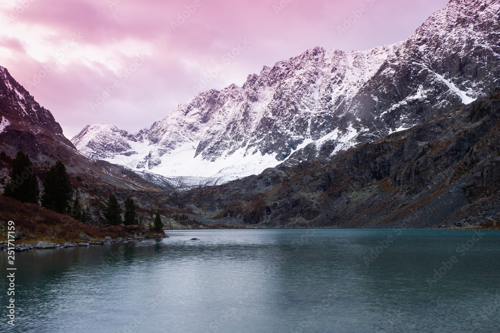 Mountain lake in winter. Dawn in rocks. Travel in mountain valley along river