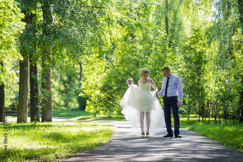 Fototapeta premium Russian bride and groom together in green city park