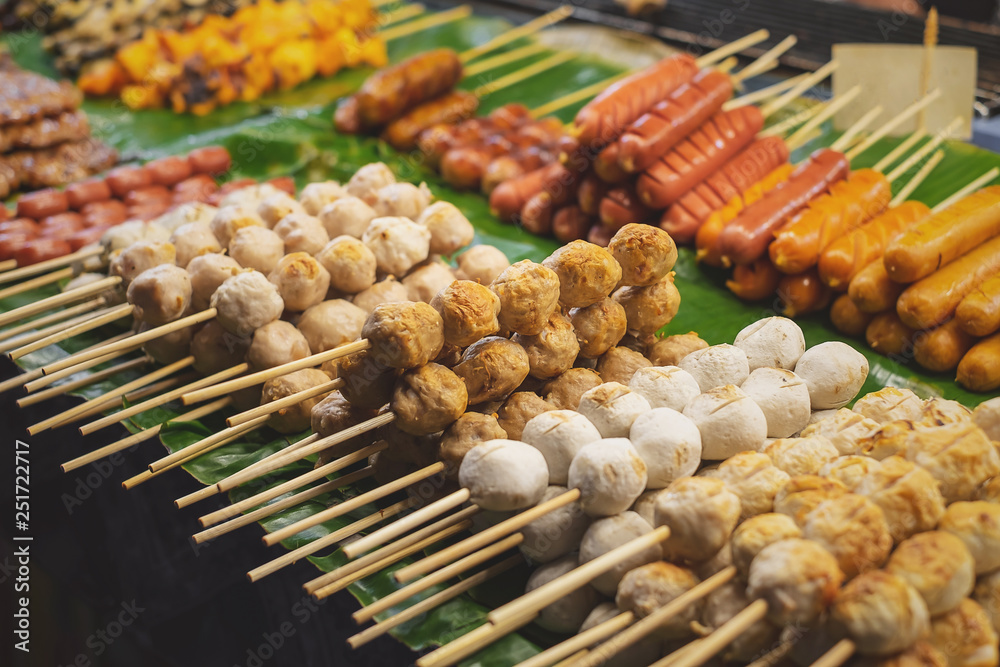 Variety of skewer meat on display at a street food stall in Bangkok Thailand.