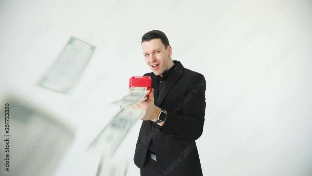 Successful business or winning the lottery. Man in suit throwing money. cash cannon money gun. Slow motion Successful business or winning the lottery. Man in suit throwing money. cash cannon money gun. Slow motion