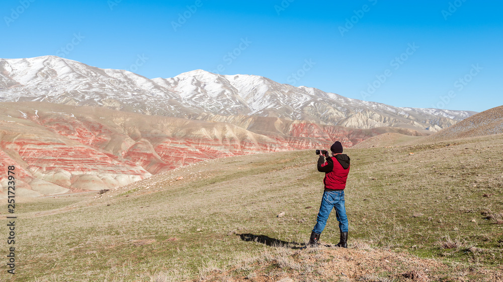 Nature photographer traveler in the red mountains