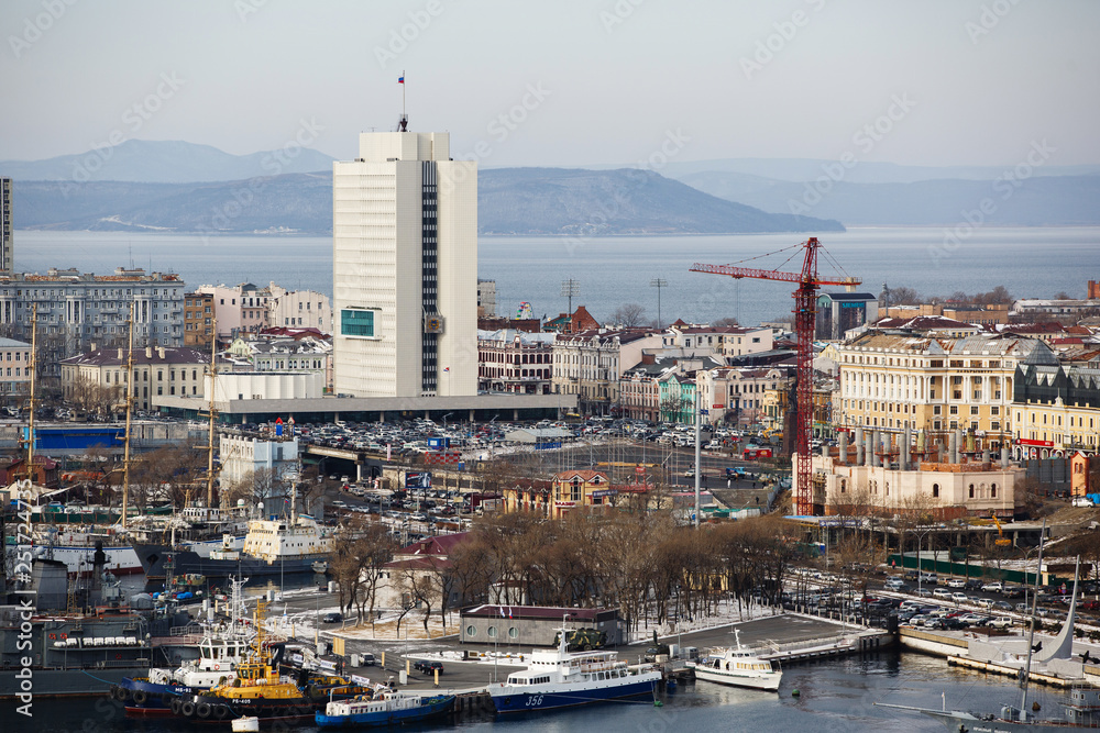 2013 - Sea facade in the capital of the Far East, the city of Vladivostok. Sea trading port with ships. Drifting ships in the raid.	