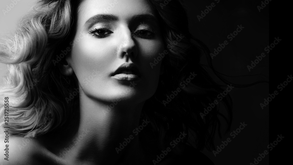 High contrast black and white portrait of a beautiful young girl, elagance and fashion