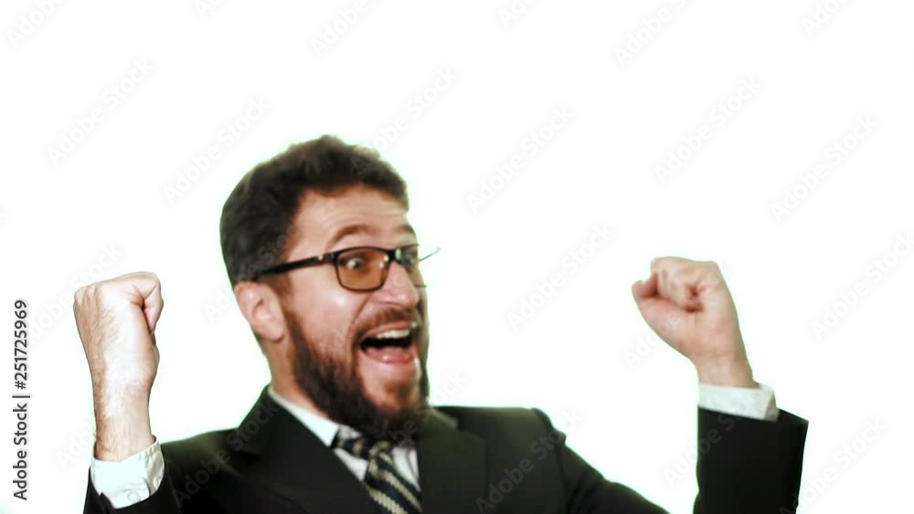 Bearded businessman wearing glasses and a suit on a white background. He is a winner, thrilled grabs his head and happy, slow motion Bearded businessman wearing glasses and a suit on a white background. He is a winner, thrilled grabs his head and happy, slow motion