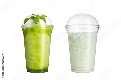 Delicious fruit smoothies in plastic cups, on a white background. Two cocktails with a taste of kiwi and milk.