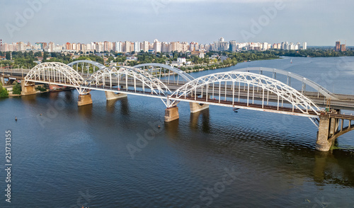 Aerial top view of automobile and railroad Darnitsky bridge across Dnieper river from above, Kiev (Kyiv) city skyline, Ukraine © Iuliia Sokolovska