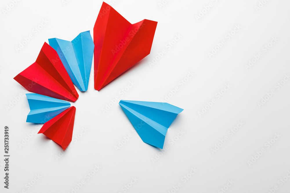 Red and blue paper planes on white background. Leadership and Business competition concepts Red and blue paper planes on white background. Leadership and Business competition concepts
