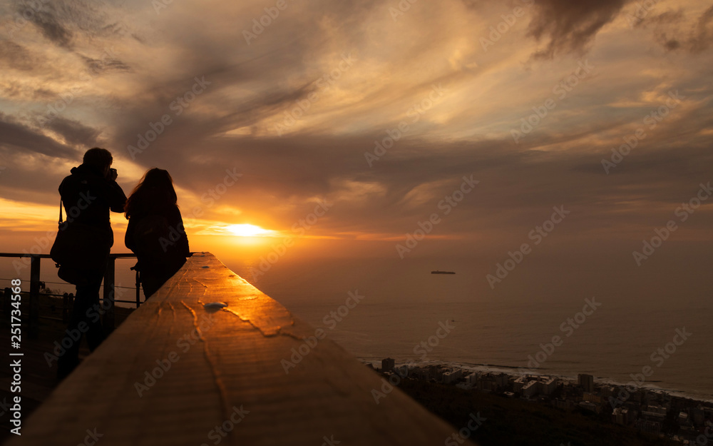 Tourist is taking a picture of sunset at view point . capetown . south africa