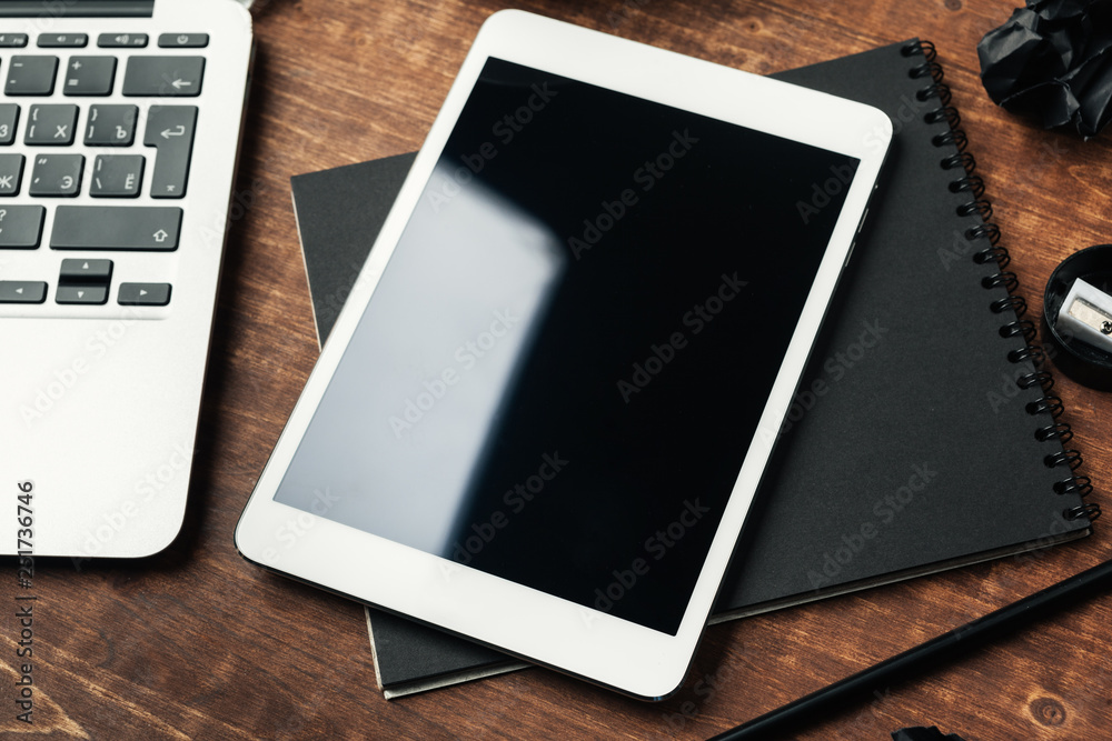 electronic gadgets and office supplies on wooden table electronic gadgets and office supplies on wooden table