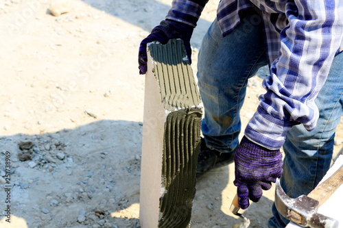 Construction technicians are building brick walls with lightweight bricks.