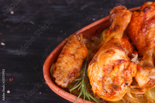 Chicken in paprika sauce baked in the oven in pottery. Chicken legs and wings