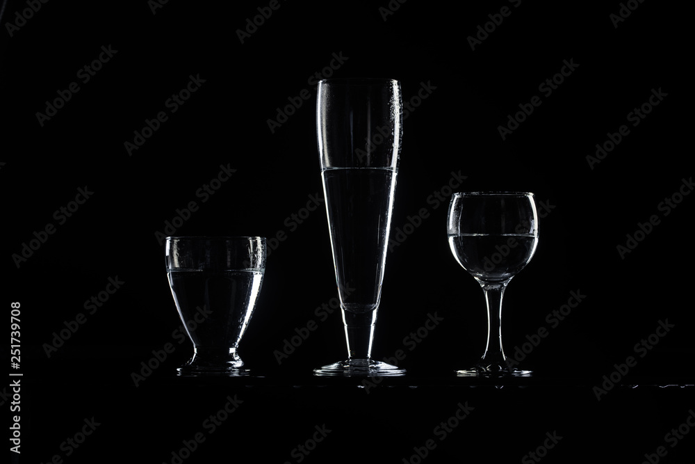 set of transparent glasses on black background set of transparent glasses on black background