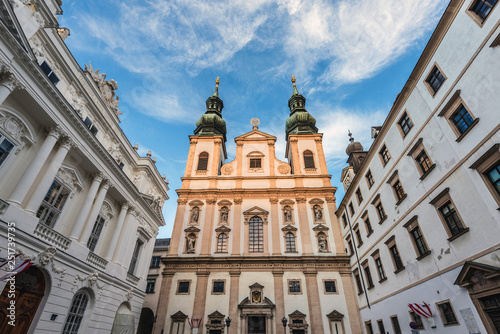 Vienna, Austria - December 31, 2017. View of Jesuit Church double tower. Viennese University church facade in golden evening light.