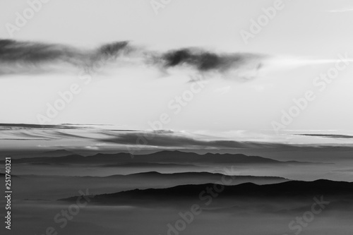 Fog filling a valley in Umbria (Italy), with layers of mountains and hills