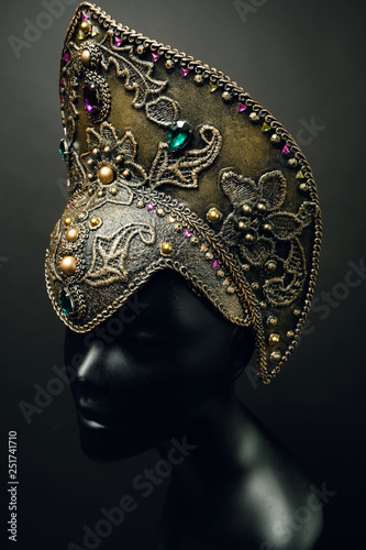 Mannequin head in creative Russian dark gold kokoshnick with jewels