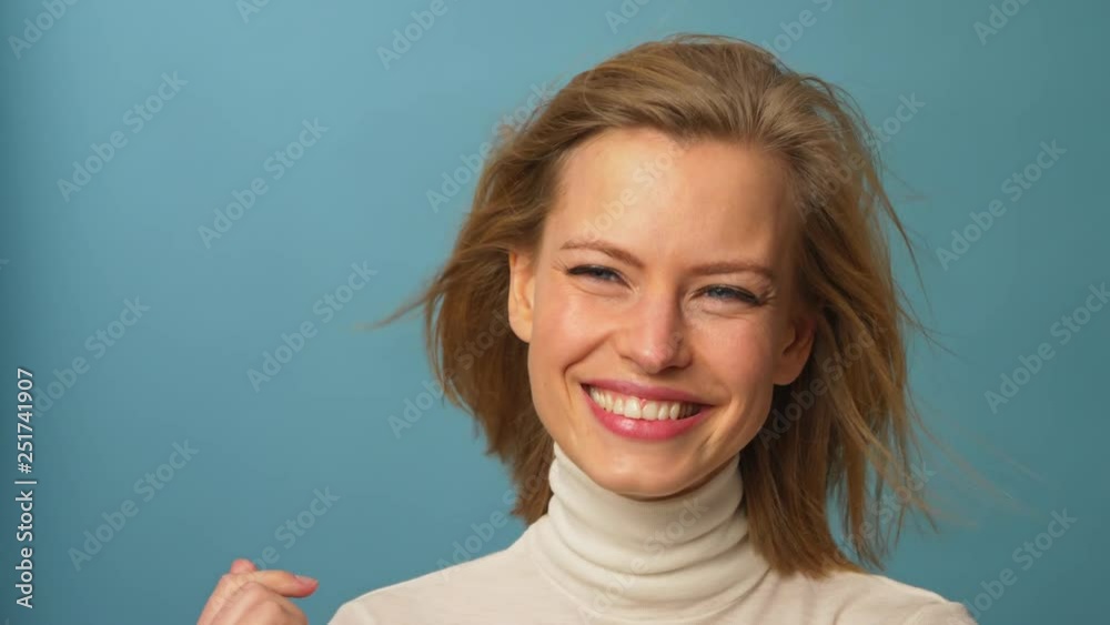 Model smiling wind blowing hair back Model smiling wind blowing hair back