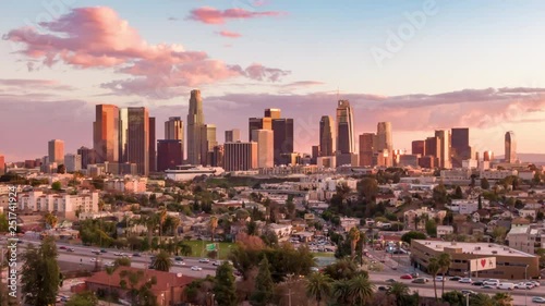 Aerial time lapse in motion or hyperlapse over Echo Park of downtown Los Angeles, California skyline and skyscrapers from above on a sunny day during golden hour before sunset. photo