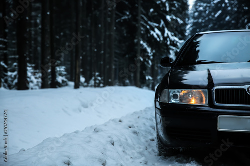 Car on road at snowy winter resort © Pixel-Shot