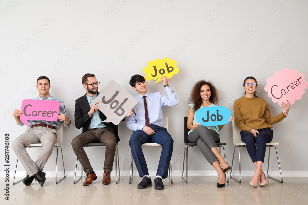 Young people holding speech bubbles with words JOB and CAREER indoors - obrazy, fototapety, plakaty 