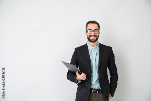 Portrait of young businessman on light background photo