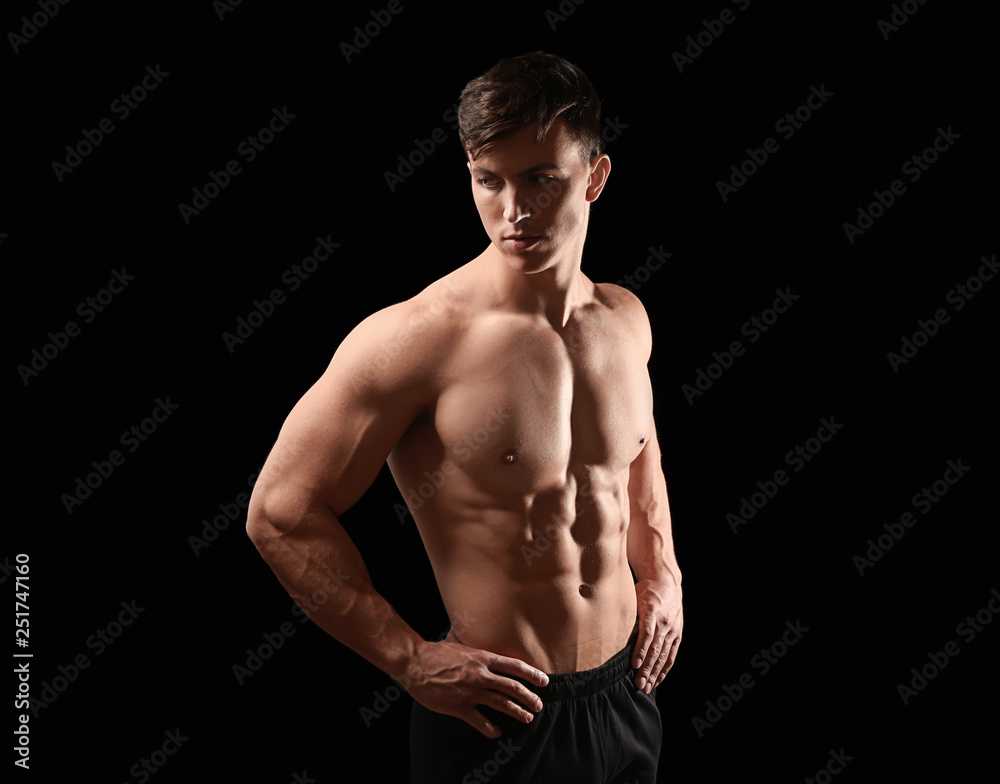 Muscular bodybuilder on dark background