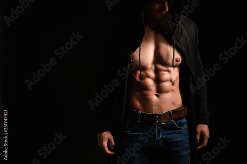 Muscular sexy bodybuilder on dark background