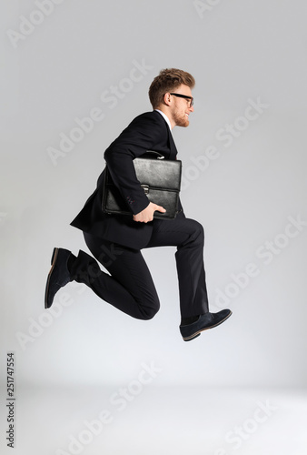 Jumping businessman with st...