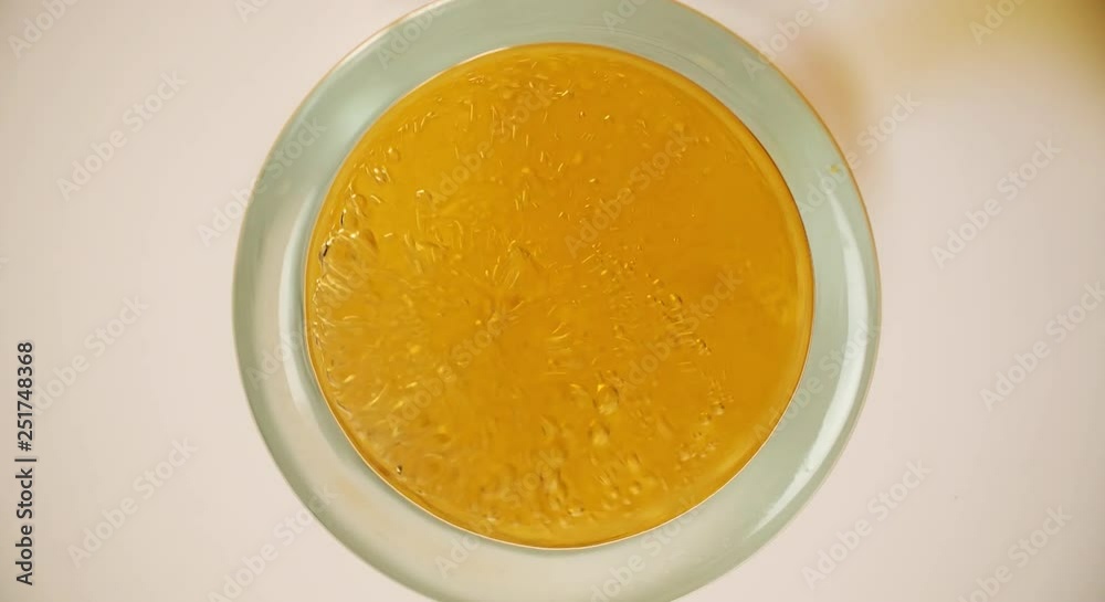 Beer is pouring and foaming in Glass from Bottom View Extremely closeup video Beer is pouring and foaming in Glass from Bottom View Extremely closeup video