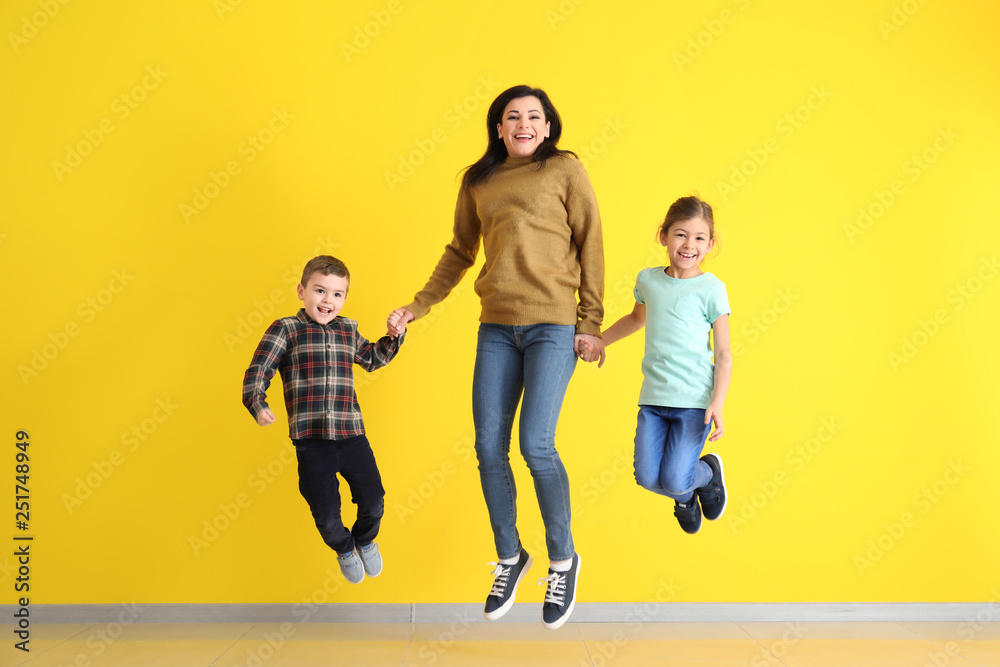 Happy jumping family on color background Happy jumping family on color background