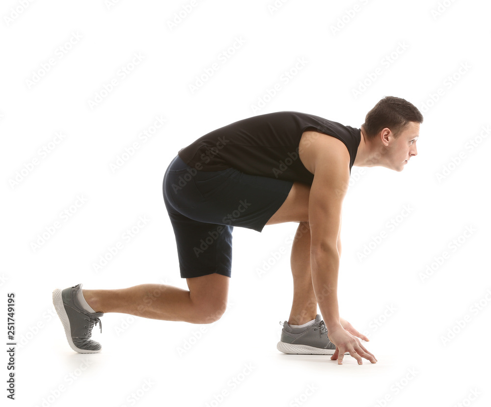 Sporty young man in crouch start position against white background Sporty young man in crouch start position against white background