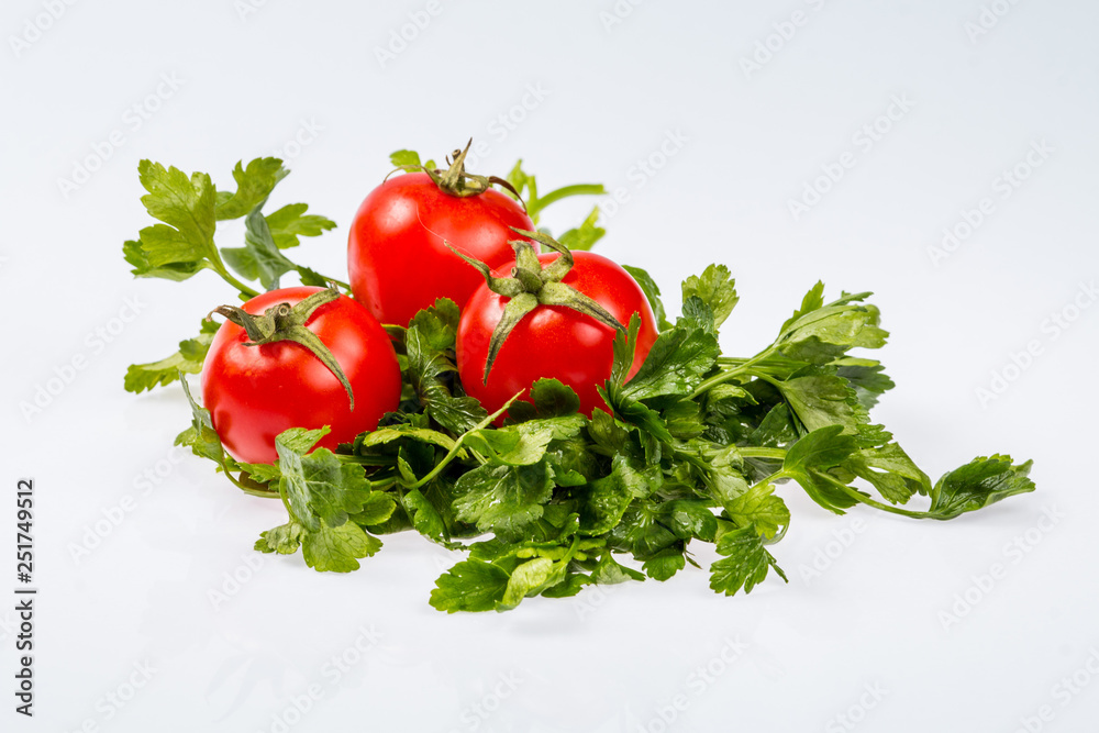 ripe fresh green bunch of parsley with three tomatoes, shiny ingredient on white background ripe fresh green bunch of parsley with three tomatoes, shiny ingredient on white background