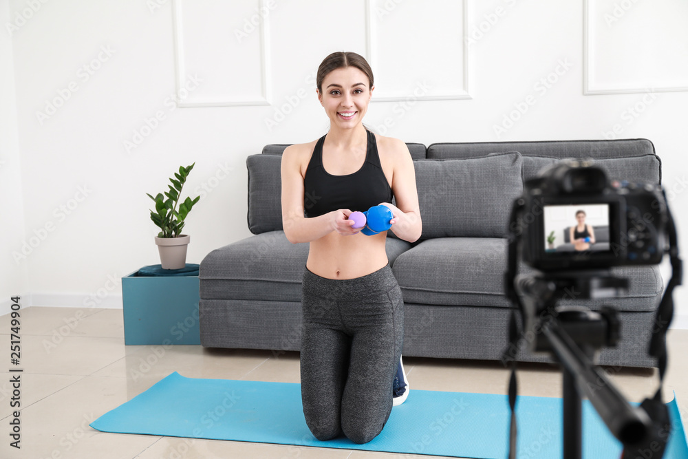 Female blogger recording sports video indoors Female blogger recording sports video indoors