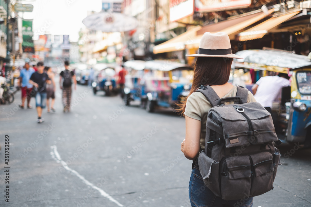 Back view Asian woman tourist backpacker travel in Khao San road, Bangkok, Thailand Back view Asian woman tourist backpacker travel in Khao San road, Bangkok, Thailand