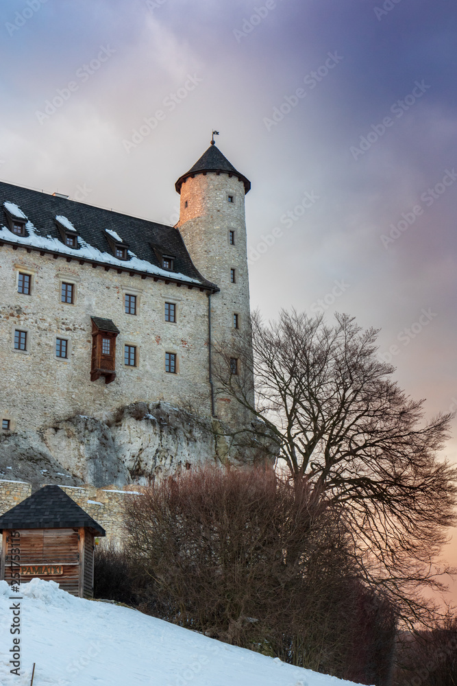 A beautifully restored royal castle Bobolice in a winter aura, sunset, Trail of the Eagles' Nests, Poland