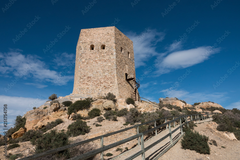 Tower of Santa Elena on a sunny day in La Azohia, Murcia, Spain. There is a walking path to climb it. Azohia is a small village located between Puerto de Mazarron and Cartagena.